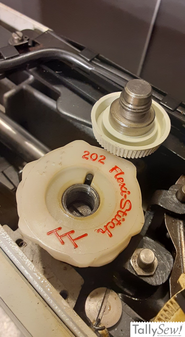 Flexi stitch cam with the retainer screw removed