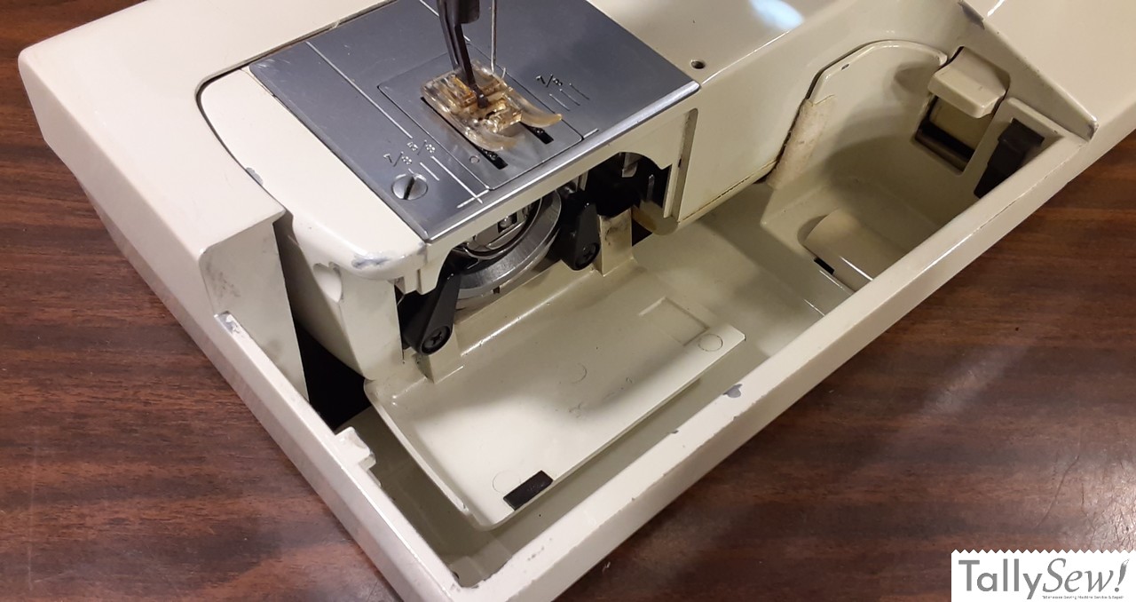 Bed extension front/top cover removed allowing access to the bobbin case and bobbin