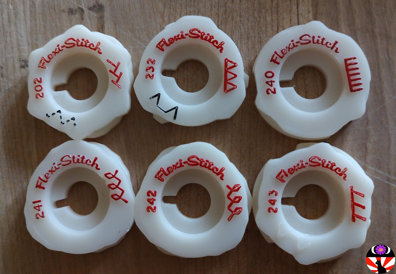 A group of six Singer Flexi-Stitch Type D stitch pattern cams