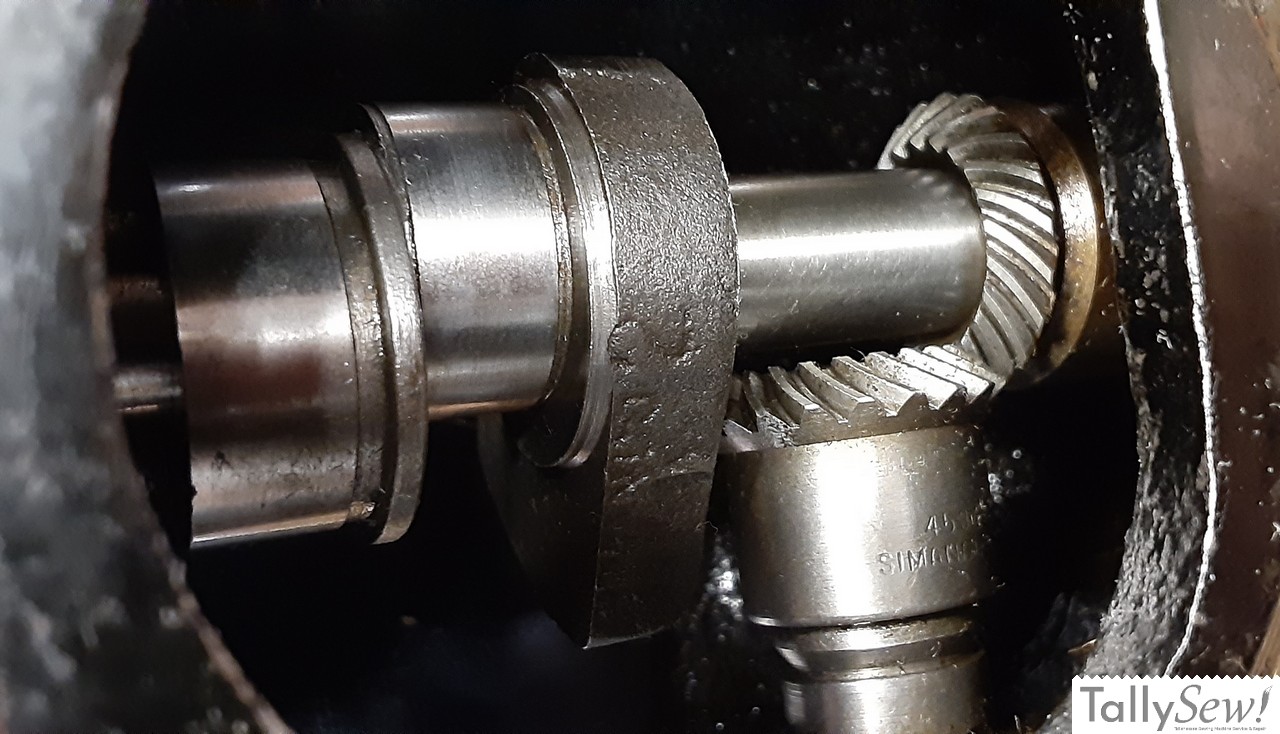 Close-up view of the all-metal upper gears in a Singer 201-2, showing the upper drive gear (left) attached to the vertical drive shaft.