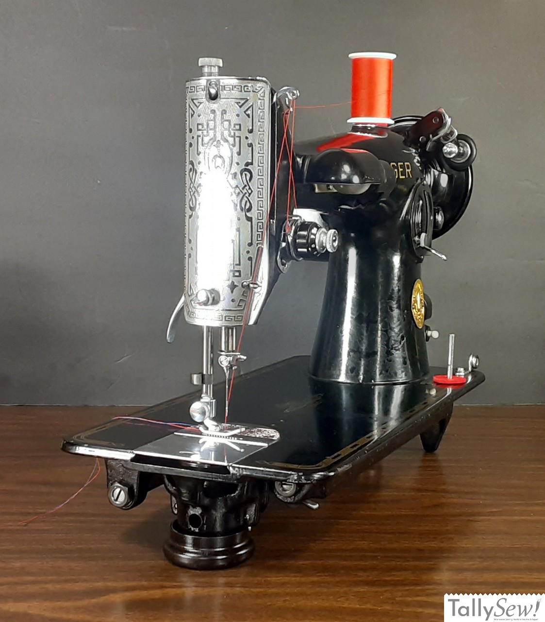 Left side view of a vintage Singer 201-2 sewing machine, showing the needle assembly and integrated front lamp.