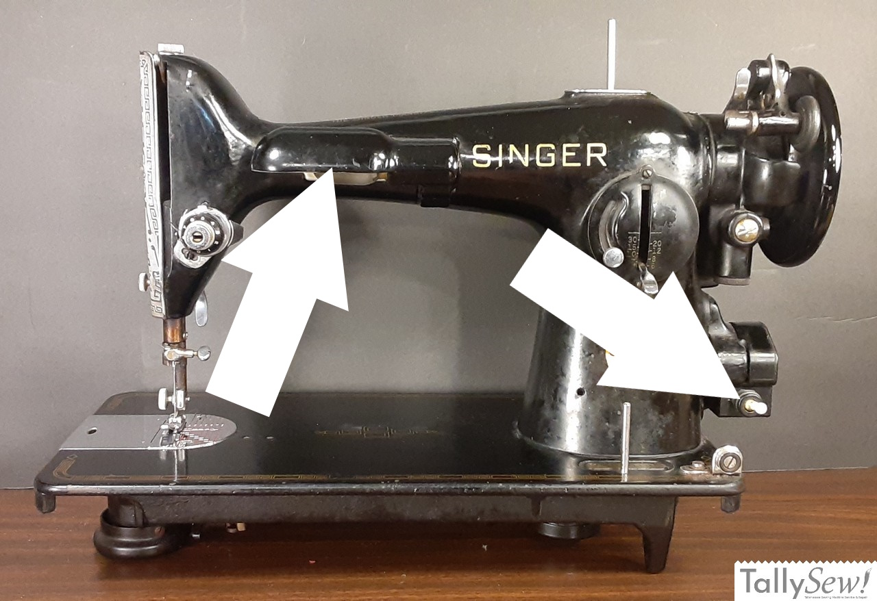 A view of a Singer 201-2 with annotated arrows identifying its lighting system. The left arrow points to the integrated front lamp, and the right arrow highlights the light switch, which is uniquely built into the machine's electrical plug housing.