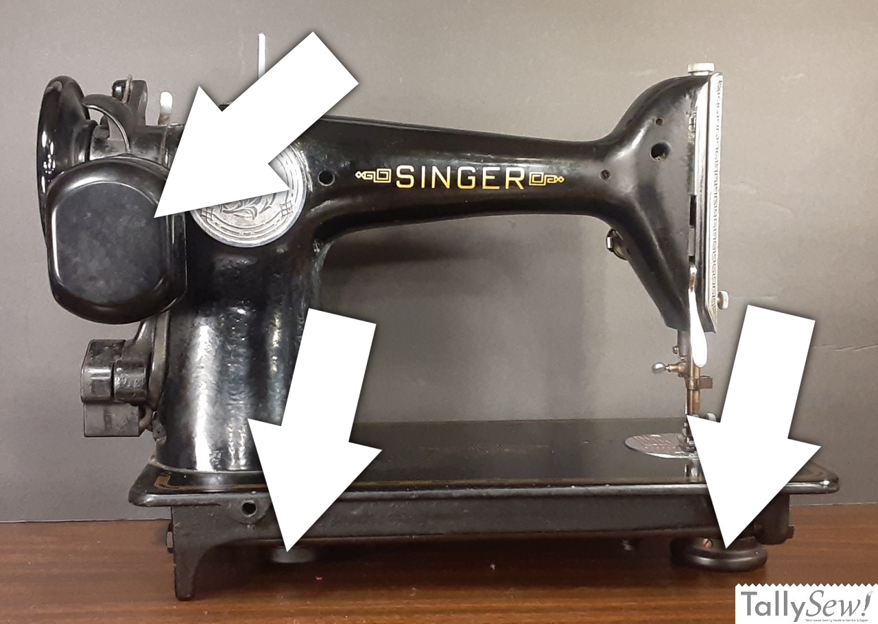 A rear view of a Singer 201-2 sewing machine with annotated arrows identifying key features. The top arrow points to the iconic potted motor, while the two lower arrows indicate the gear covers