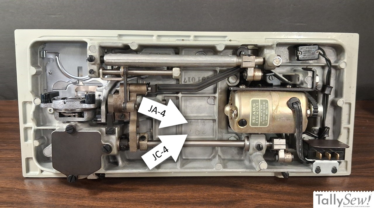 Underside of vintage Kenmore sewing machine showing JA-4 and JC-4 factory casting marks